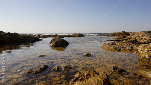 Sardegna sea rocks in the mediterranean with crystal clear water and reflections of the sun, copyspace nature © Click Estudio