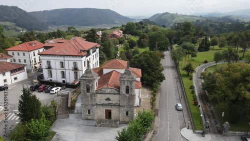 Aerial shot of an old church in Colombres (Asturias) with mountains and green countryside in the surrounding area photo
