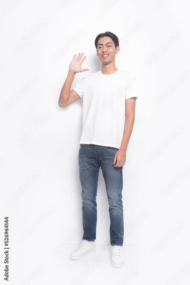Full body portrait of a young man in a white t-shirt. jeans with stop gesture , casual fashion. Full body portrait of a young man in a white t-shirt. jeans with stop gesture , casual fashion.