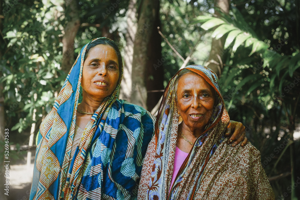 South asian aged sisters holding each other in a village, sisterhood in rural women South asian aged sisters holding each other in a village, sisterhood in rural women