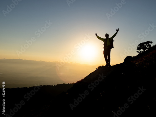 silhouette of mountaineer in summit mountains