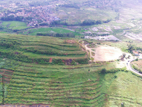 Abstract Defocused Blurred Background Scenic view Stunning green hills, covered by cloud shadows in Cicalengka area - Indonesia. Not Focus photo