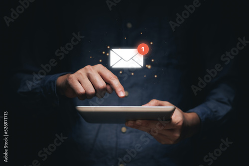 Businessman holding tablet and touching with virtual white newsletter for E-mail Erelectronic mail with notification alert concept.