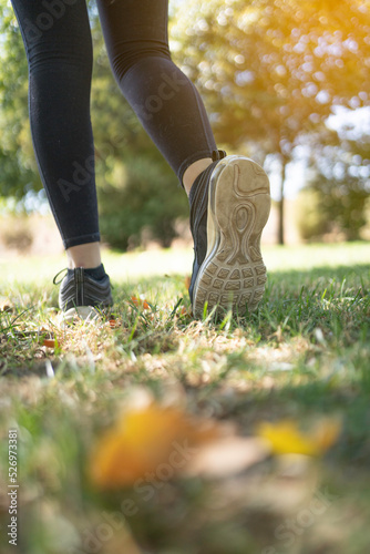 Runner feet running in park. woman.fitness training body wellness concept.