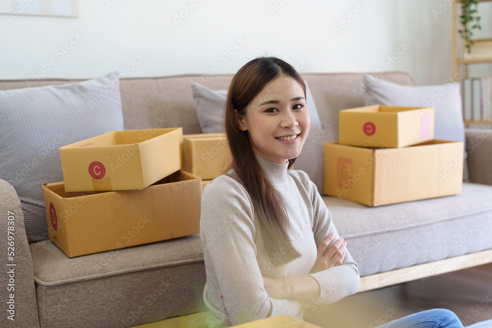 A businesswoman sells items online and checks the goods for packing A businesswoman sells items online and checks the goods for packing