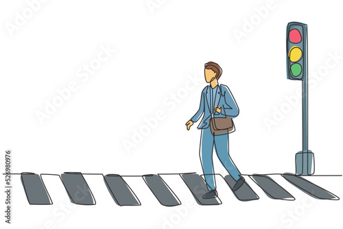 Continuous one line drawing a male worker crosses the road on the zebra crossing after returning from work. There's a traffic light there too. Single line draw design vector graphic illustration.