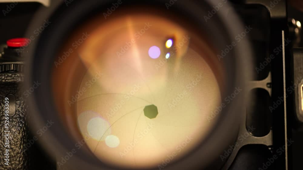 Close-up of opening and closing the aperture on a photographic lens. Camera settings for professionals in the studio. 4k