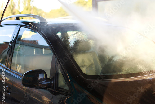close-up washing a car from a spray a self-service car wash