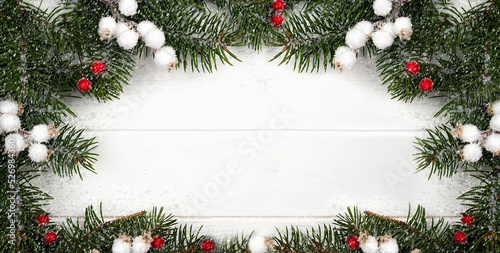 Christmas and New Year composition of fir branches and snowflakes in the form of a frame. Banner. Winter background. Flatlay. Top view. Copy space.
