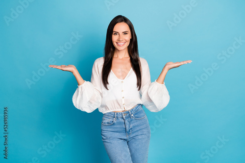 Photo of nice brunette lady hold arms wear white shirt jeans isolated on blue color background