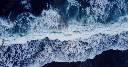 Aerial view texture of big power dark ocean waves with blue ocean. Aerial top-view footage of fabulous sea tide on a stormy day. Drone filming breaking surf with foam in Andaman sea. 4K 4096x2160p
