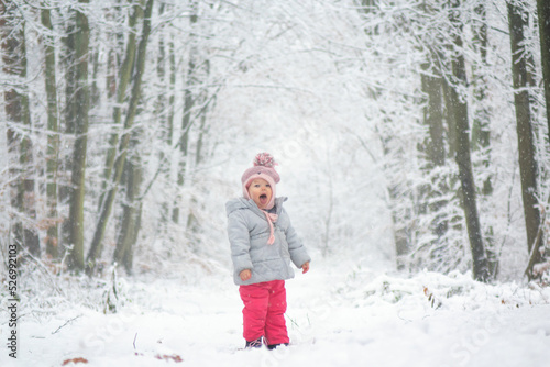 Child in snow in forest