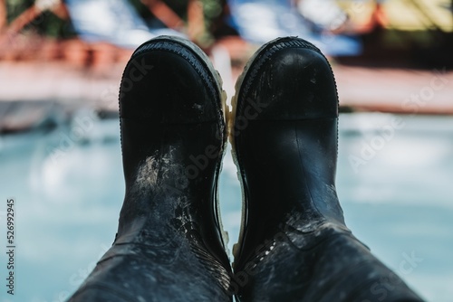 Closeup shot of black hiking rainboots in the Peruvian Amazonia rainforest photo