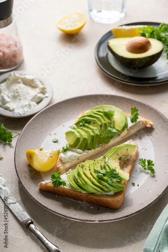 Avocado toast with cream cheese, lemon and herbs. Homemade healthy food
