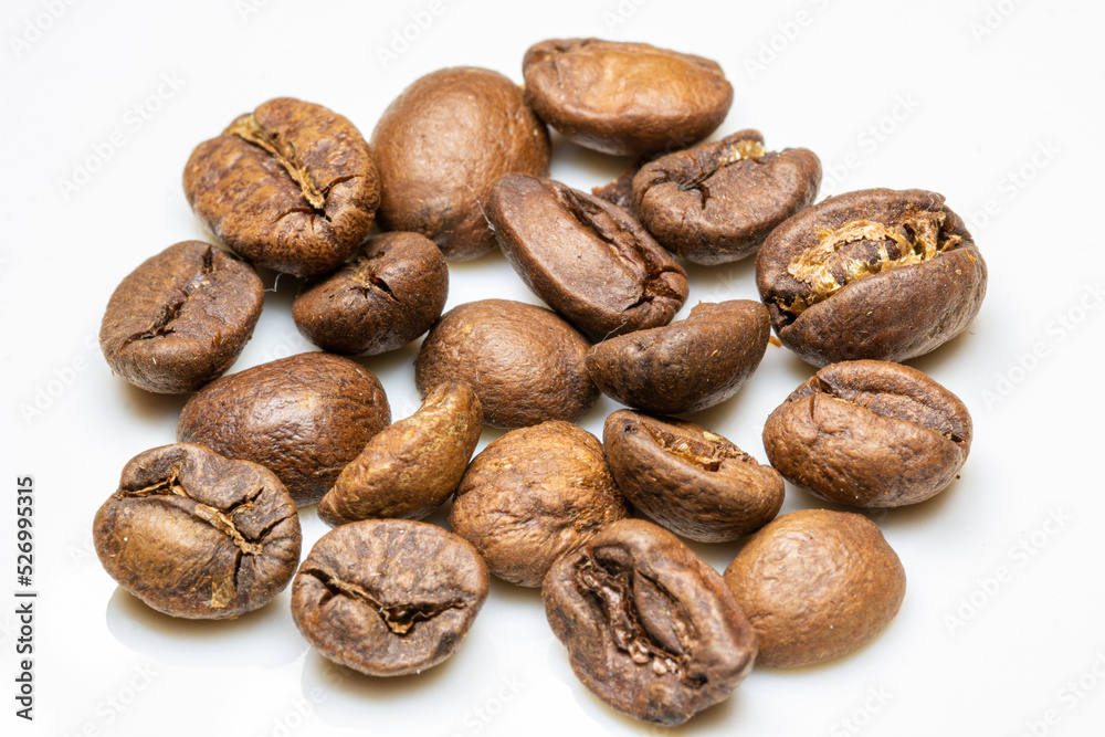 heap of medium Roasted coffee beans on white background. macro photo heap of medium Roasted coffee beans on white background. macro photo