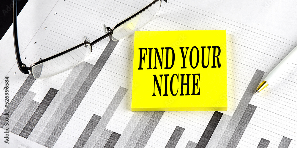 Word FIND YOUR NICHE on yellow sticky on the chart background Word FIND YOUR NICHE on yellow sticky on the chart background