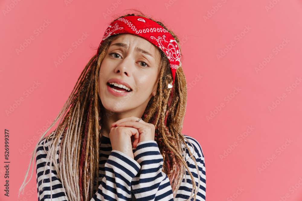 White woman with dreadlocks frowning while looking at camera White woman with dreadlocks frowning while looking at camera