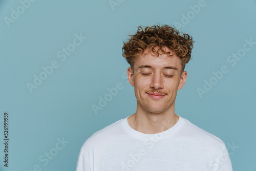 Tableau sur toile Portrait of young handsome curly man with closed eyes