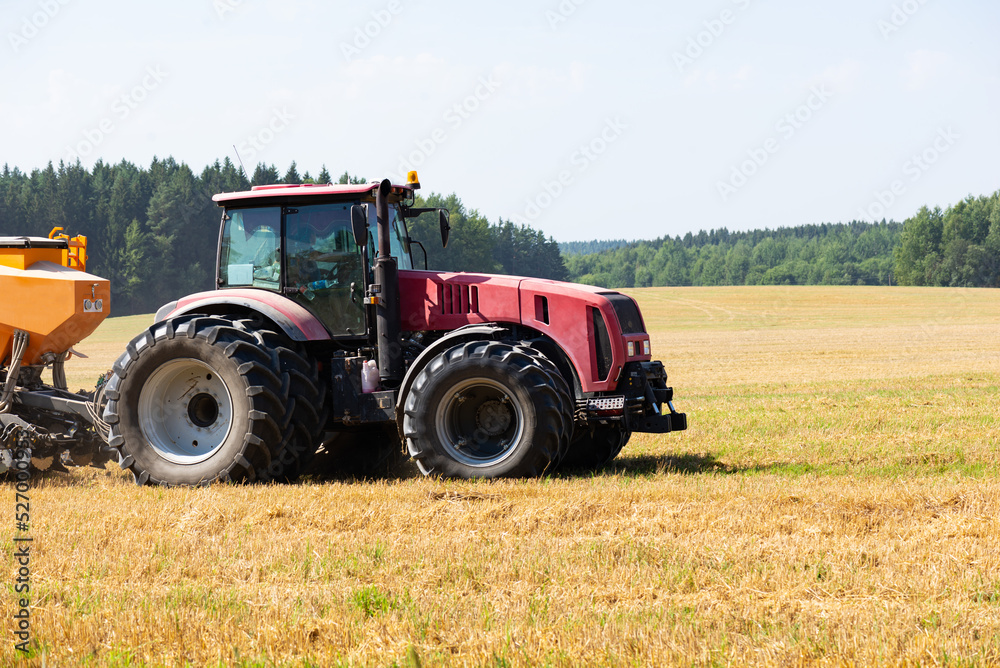 Tractor on the field harvests. Tractor on the field harvests.