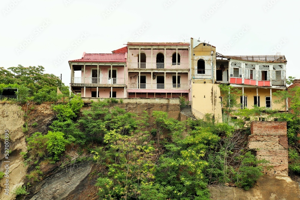 Old abandoned houses on the edge of a steep cliff
