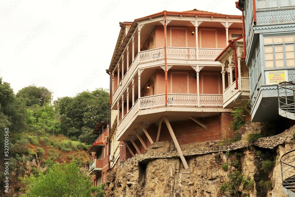 Fototapeta premium Traditional residential buildings in the old town of Tbilisi on the edge of a sheer cliff