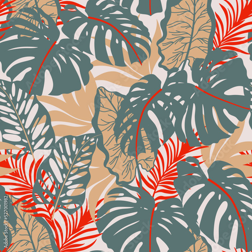 Fashionable seamless tropical pattern with bright plants and leaves on a beige background. Beautiful seamless vector floral pattern. Colorful stylish floral.