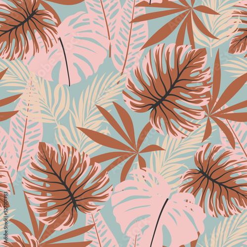 Original seamless tropical pattern with bright plants and leaves on a blue background.  Beautiful print with hand drawn exotic plants. Trendy summer Hawaii print.