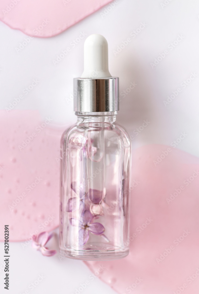 Closeup of glass dropper bottle with pipette with serum and lilac flowers. Essential oil, natural beauty cosmetics, bio science and research, skin care concept. Macro. Top view, flatlay Closeup of glass dropper bottle with pipette with serum and lilac flowers. Essential oil, natural beauty cosmetics, bio science and research, skin care concept. Macro. Top view, flatlay
