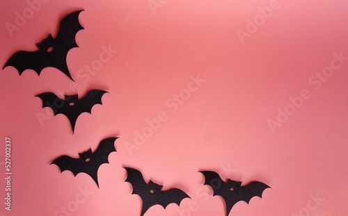 five silhouettes of bats on a pink background. Creative halloween concept backdrop. halloween bats craft.