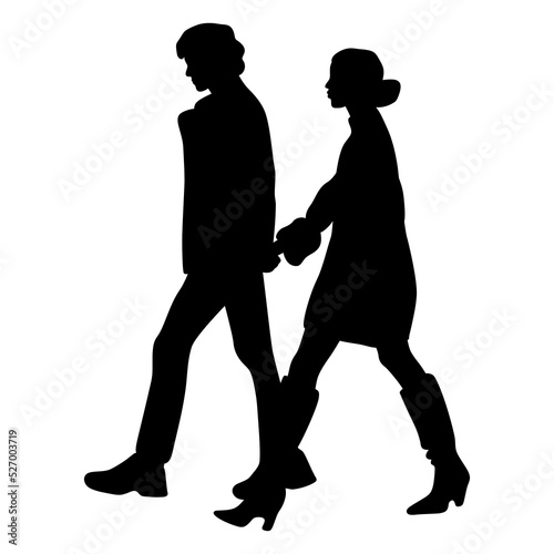 Silhouettes of man and woman walking together holding hands. Romantic couple on a formal date. Glamorous people on a stroll.