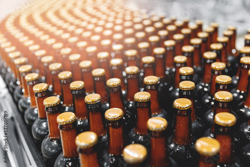 Banner set brown bottles with beer on conveyor line. Concept kraft brewery shop market