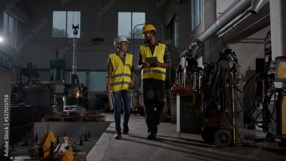 Industrial inspectors doing a general check up indoors at metal workshop. Industrial inspectors doing a general check up indoors at metal workshop.