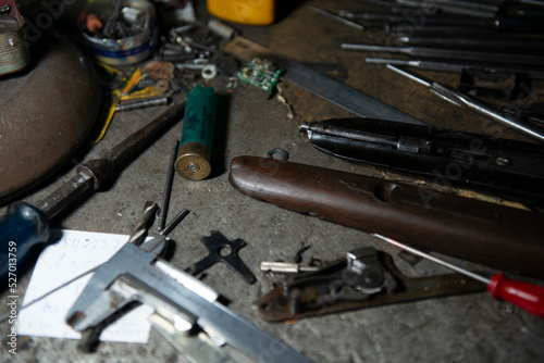 weapons workshop completion of restoration spare parts of a restored antique gun photo