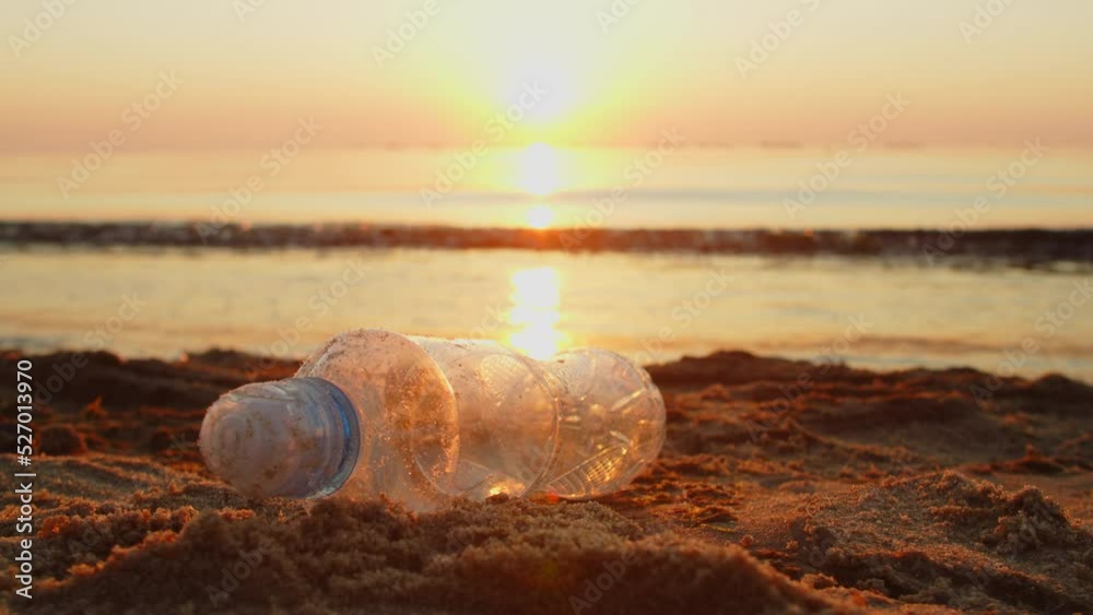 plastic bottle lies on a sandy beach, pollution of the environment and nature. Ecology environment garbage teamwork volunteer awareness pollution. Plastic trash on the beach. plastic bottle lies on a sandy beach, pollution of the environment and nature. Ecology environment garbage teamwork volunteer awareness pollution. Plastic trash on the beach.
