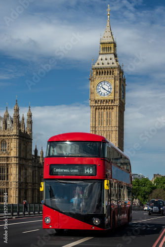 Red double decker bus on Westminster bridge  Big Ben in the background  in London  UK