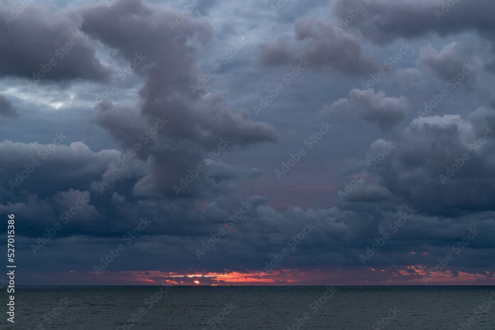 Colorful sunset and dramatic clouds at the Baltic Sea.