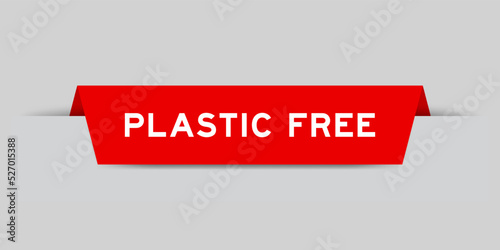Red color inserted label with word plastic free on gray background