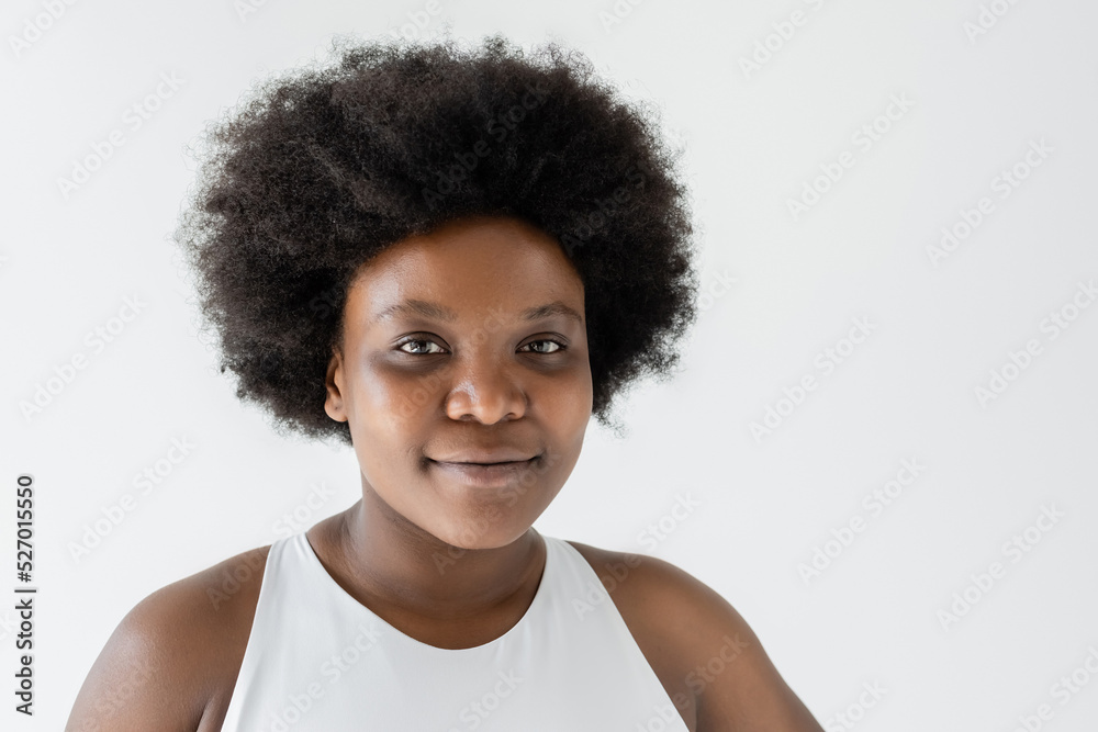 portrait of smiling african american plus size woman isolated on white.