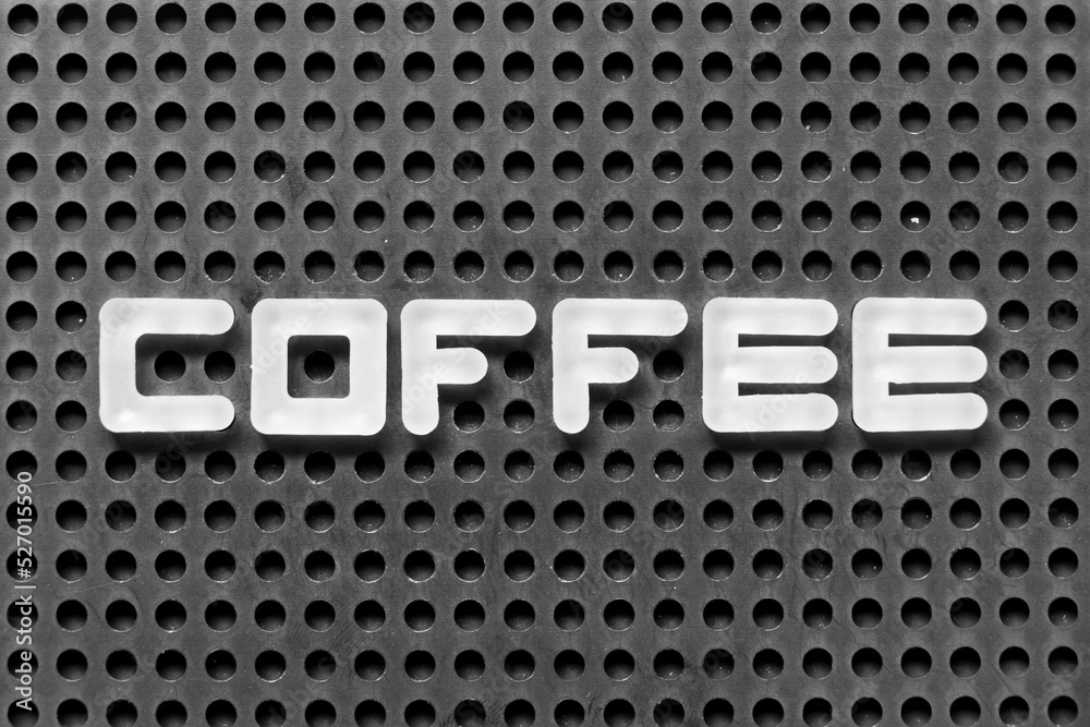 White alphabet letter in word coffee on black pegboard background White alphabet letter in word coffee on black pegboard background