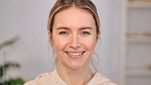 Fotografija Caucasian woman with blonde hair and green eyes looking at camera with smile