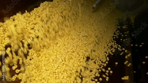 Rotating drum for mixing rings with syrup. Plant for the production of rings and flakes using extrusion. Production of dry breakfast at the factory.