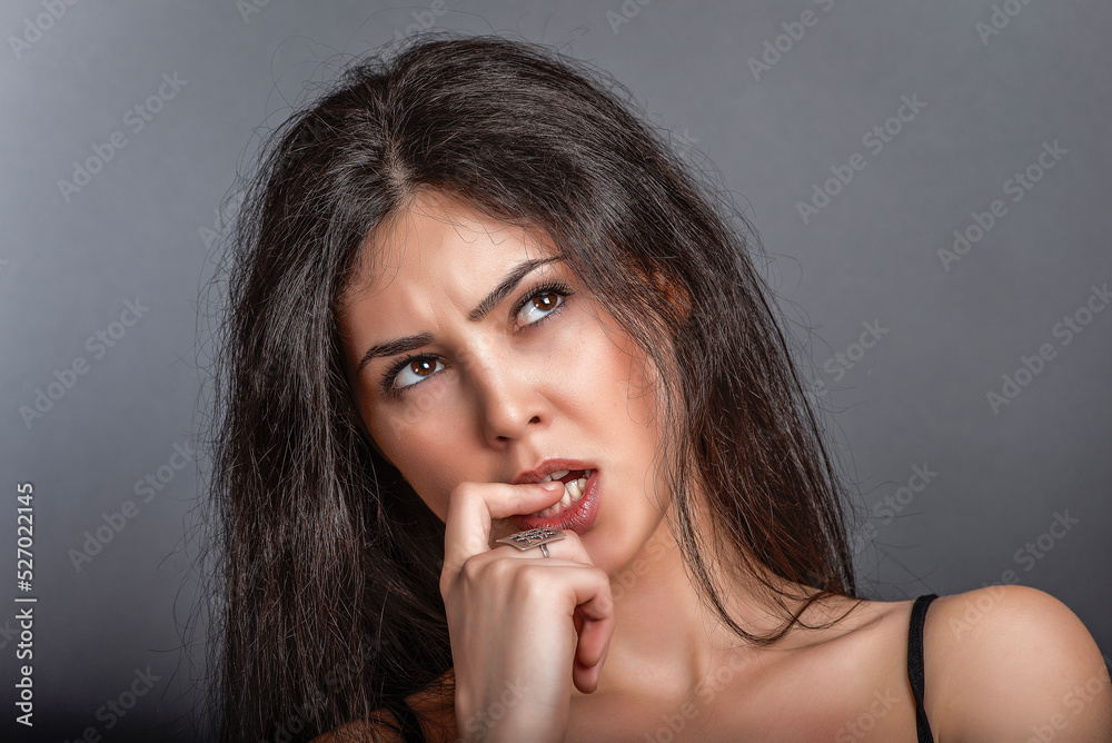 Portrait of a beautiful woman in the studio on the background. Portrait of a beautiful woman in the studio on the background.