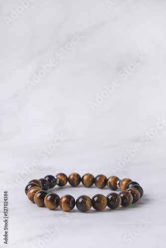 Close-up of a tiger eye bracelet on a light background