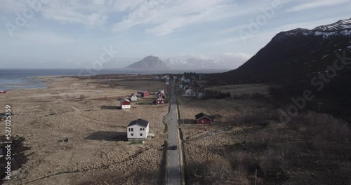 Long road towards the norwegian mountains with small houses photo