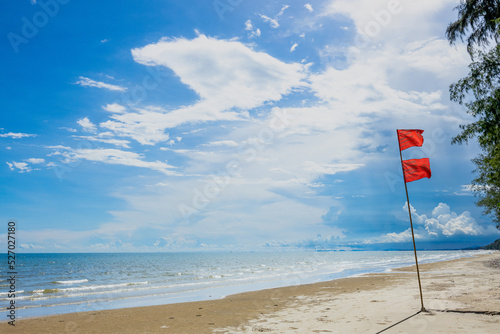 Red flags are placed on the seashore to indicate danger.