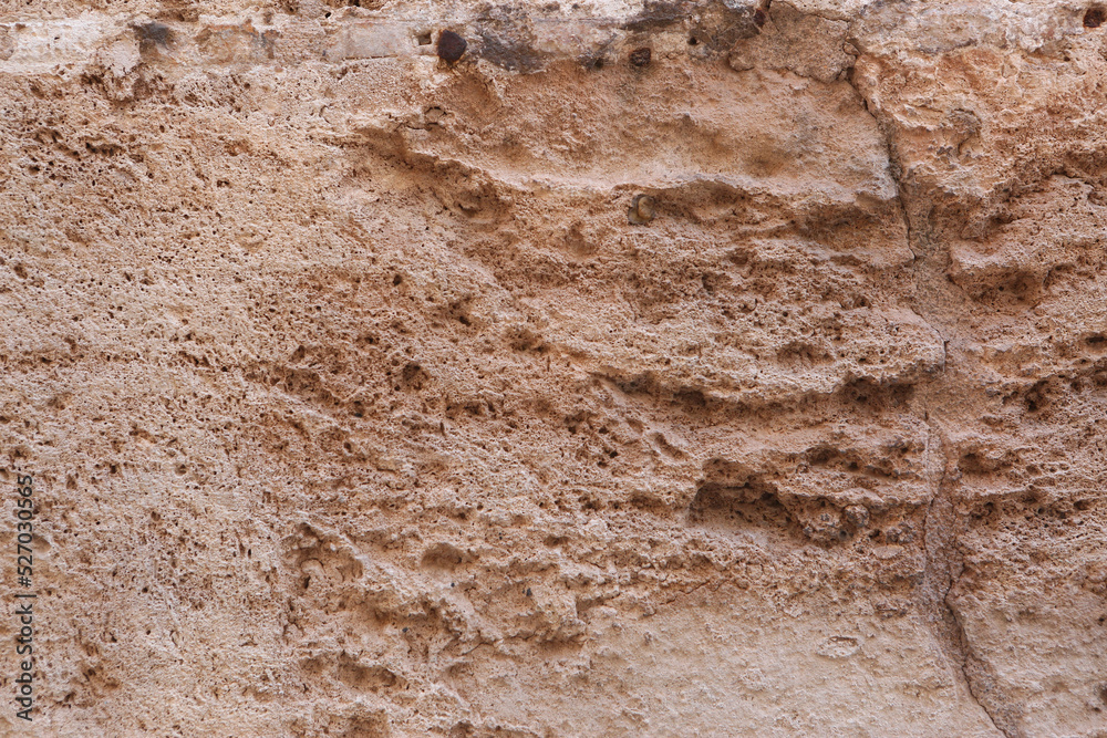 Obraz premium brown concrete wall rough abrasive surface texture closeup photo
