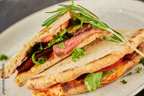Sandwich with meat, herbs and spices. Breakfast or lunch. A dish from the chef for serving in a restaurant.