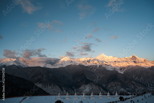 meili snow mountain at sunrise with with white pagodas, yunnan, china photo