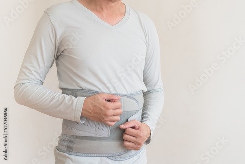 Back pain , man suffering from backache , office syndrome , Backache and lower back pain concept , support belt for back muscles .