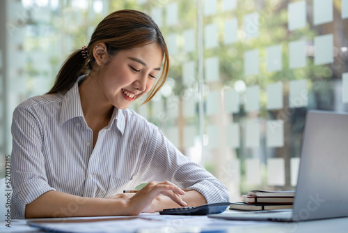 crop shot of business woman checks her work and uses a calculator to calculate her annual financial statements. Turnover and Profit Balance Sheet Making financial records in paper audits. Free Download crop shot of business woman checks her work and uses a calculator to calculate her annual financial statements. Turnover and Profit Balance Sheet Making financial records in paper audits. - GFXLoad